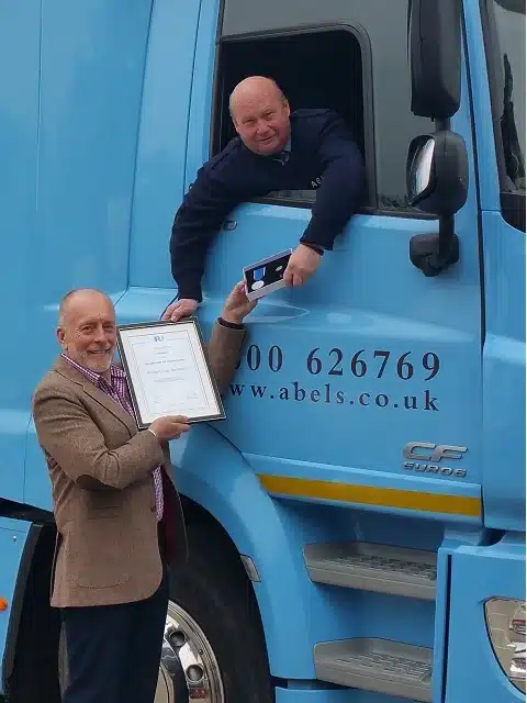 Ian Studd, Director General of the BAR, hands Bob Sanders, Senior Abels Driver his IRU Diploma