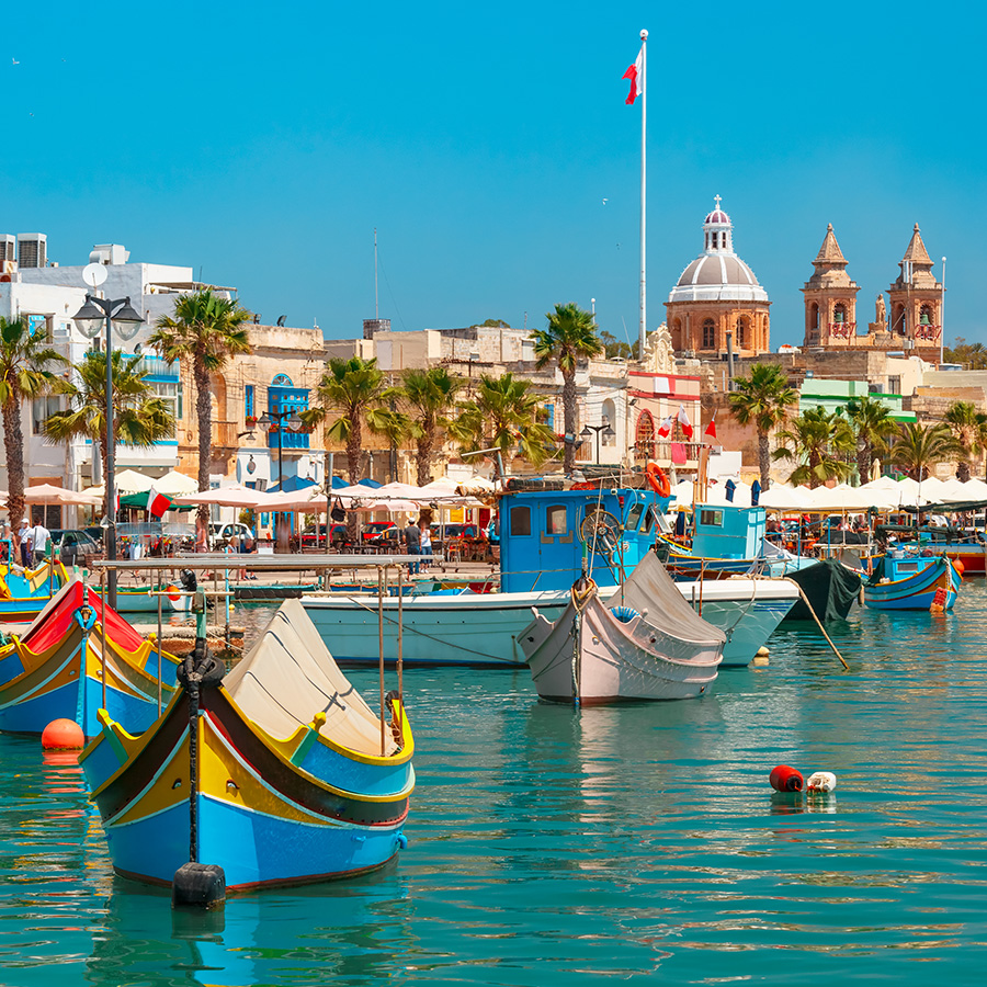 colorful boats luzzu in the harbor of mediterranean fishing village marsaxlokk, malta