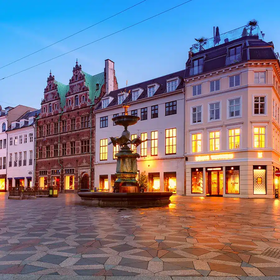 Stork fountain on the amagertorv square stroget street during morning blue hour copenhagen Denmark