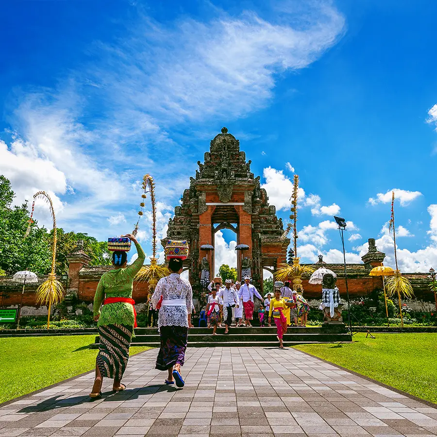 balinese people in traditional clothes during religious ceremony at pura taman ayun temple bali in indonesia