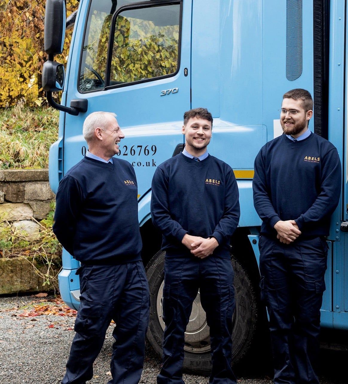 Three people in front of truck
