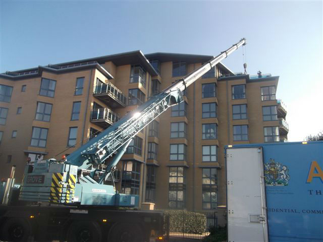 Furniture crate safely arrives on the 7th floor roof top and is unloaded by Abels removal team
